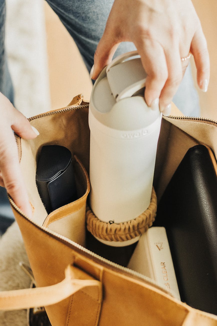 Rolling suitcase with clothes packed tightly for efficient carry-on travel.